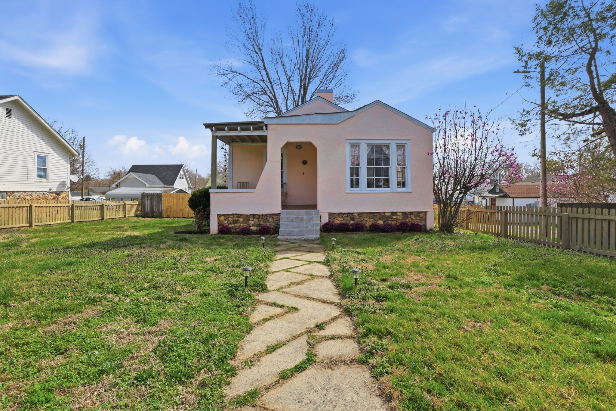 a front view of house with a garden