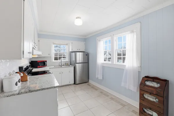 a kitchen with a refrigerator a sink and a stove top oven