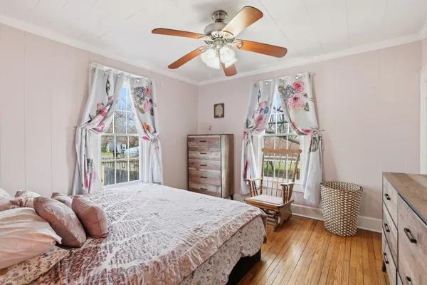a bedroom with a bed and a chandelier