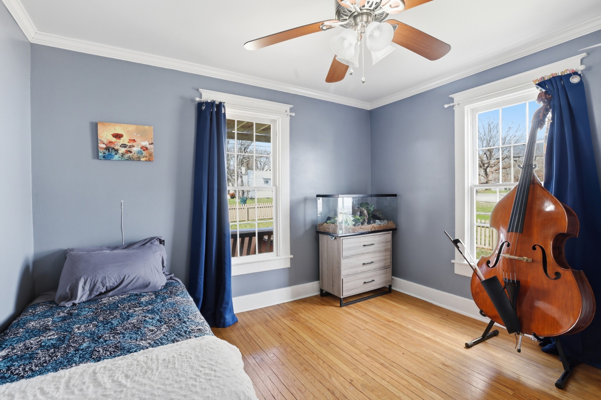 103 Freeman Avenue Dickson, TN 37055 - Photo 9 of 16 a bedroom with a bed and a chandelier fan