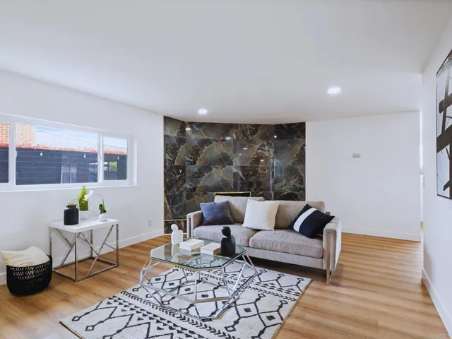 a view of empty room with wooden floor and floor to ceiling window