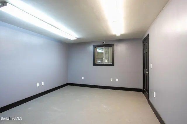 a view of a kitchen with refrigerator and workspace