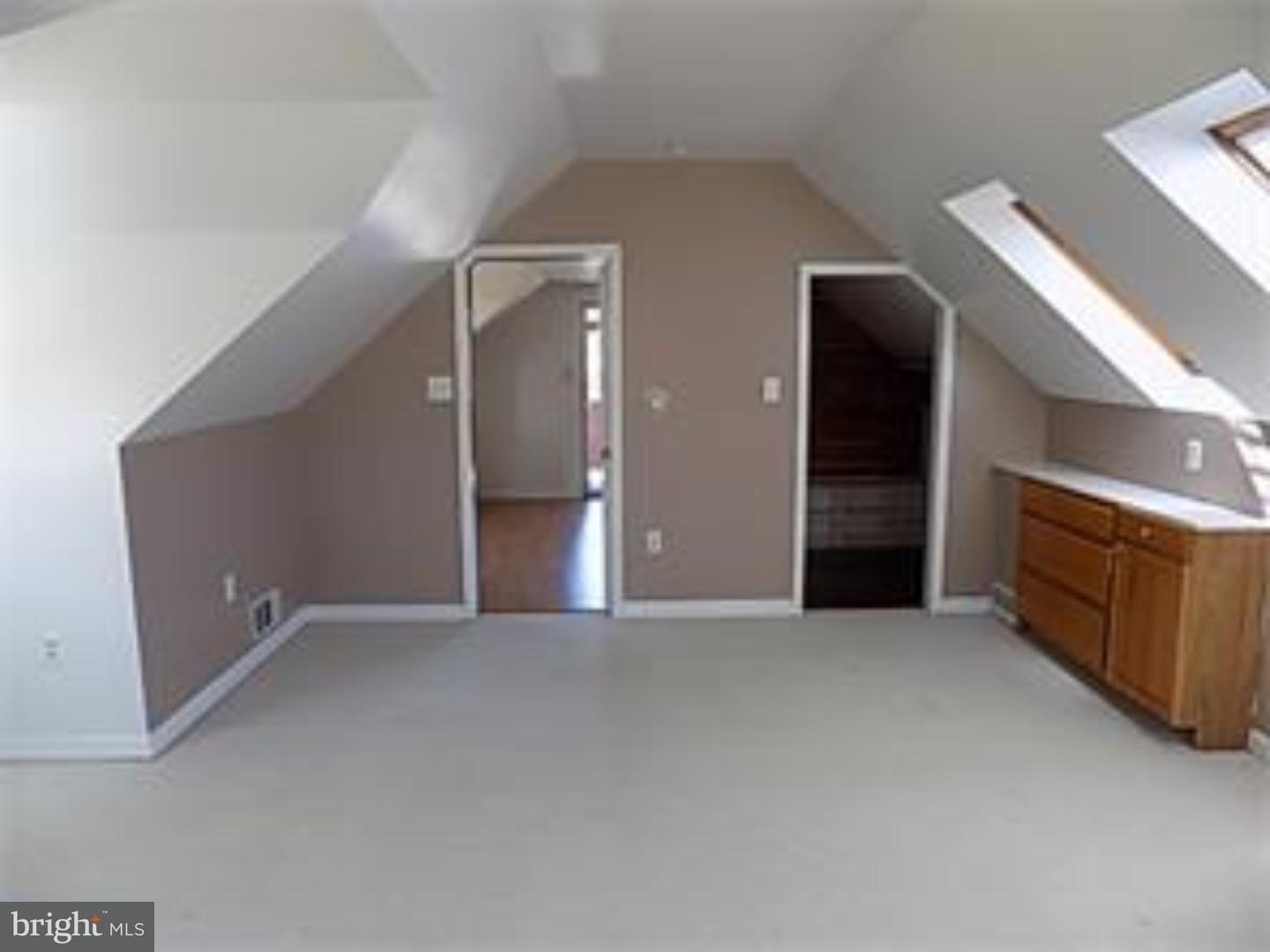 501 Exeter Road Reading, PA 19606 - Photo 12 of 14 an empty room with fireplace and windows