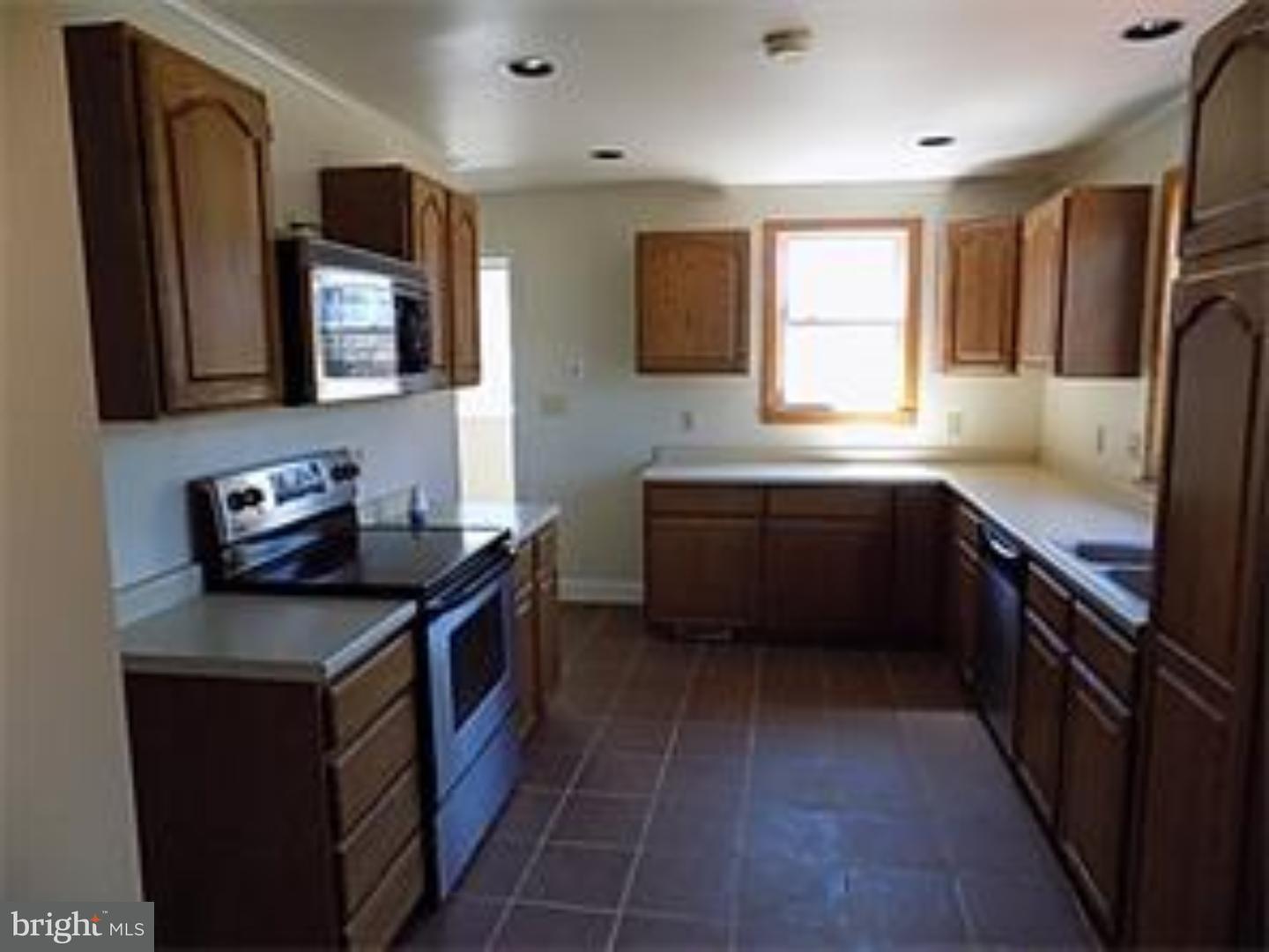 501 Exeter Road Reading, PA 19606 - Photo 3 of 14 a kitchen with stainless steel appliances granite countertop a sink stove and refrigerator