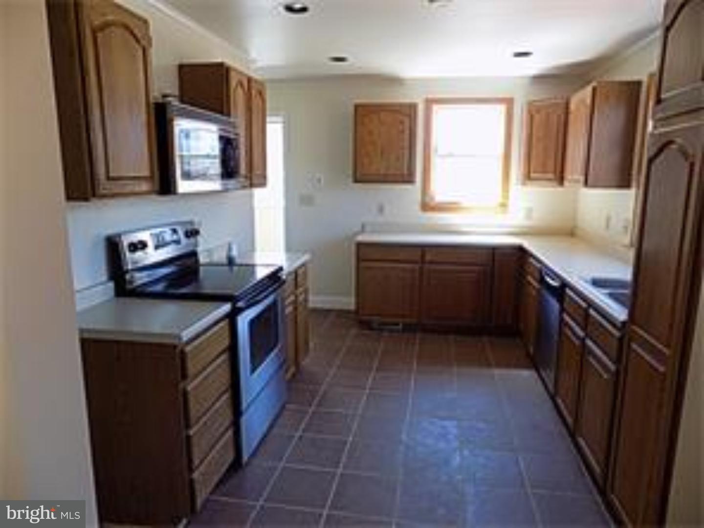 501 Exeter Road Reading, PA 19606 - Photo 4 of 14 a kitchen with a stove top oven sink and cabinets