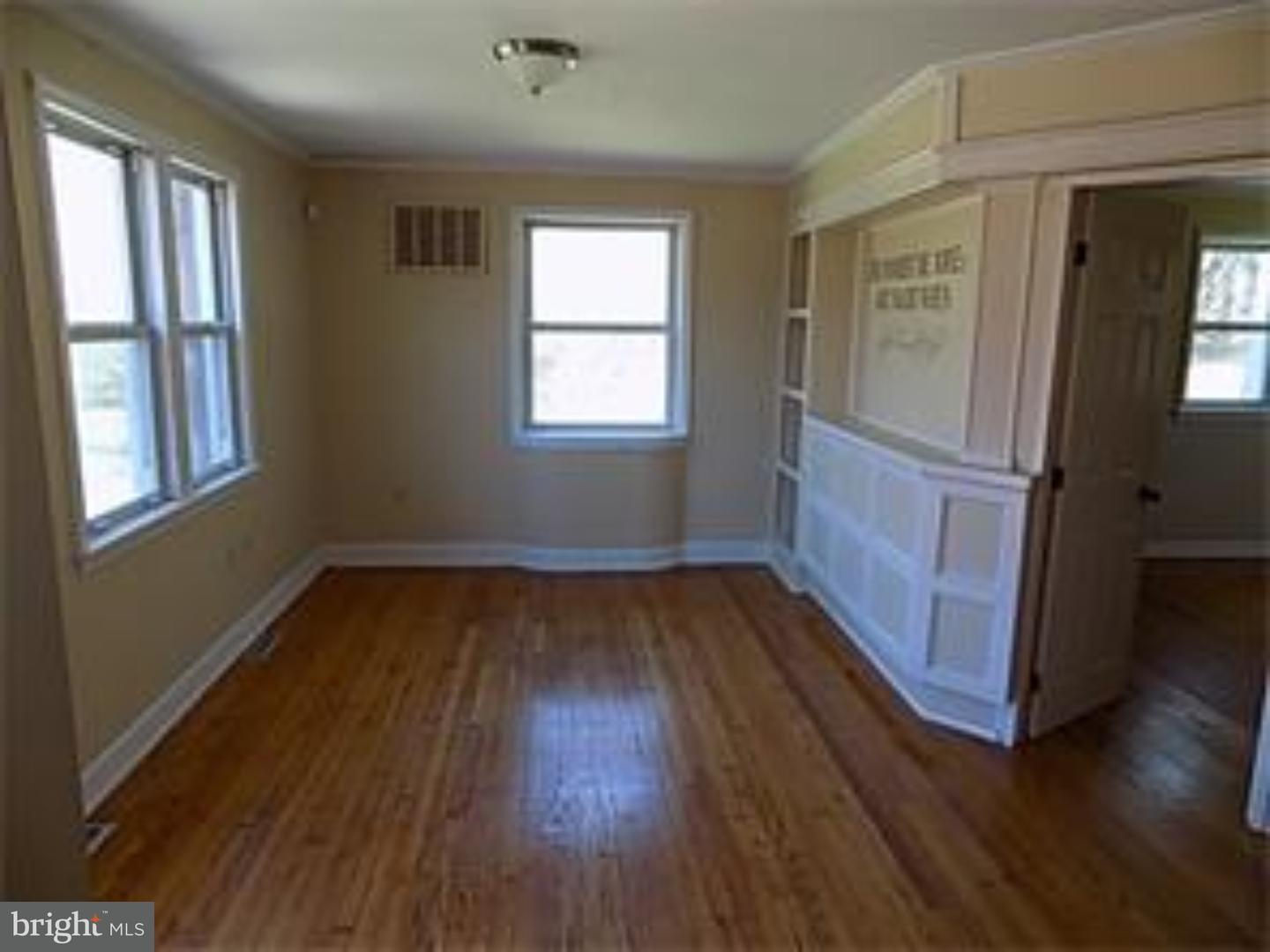 501 Exeter Road Reading, PA 19606 - Photo 5 of 14 an empty room with wooden floor and windows