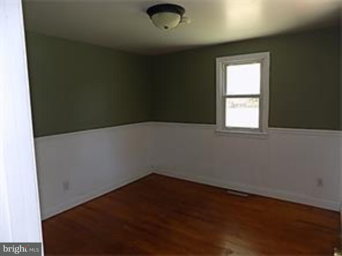 501 Exeter Road Reading, PA 19606 - Photo 7 of 14 an empty room with wooden floor and windows