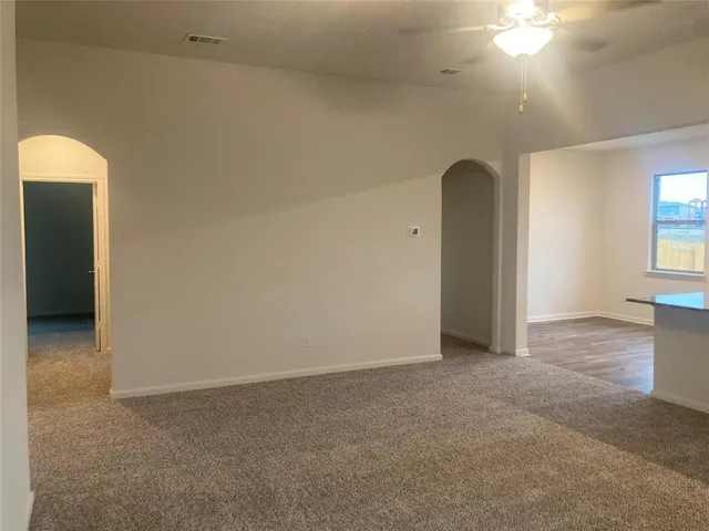 an empty room with windows and closet