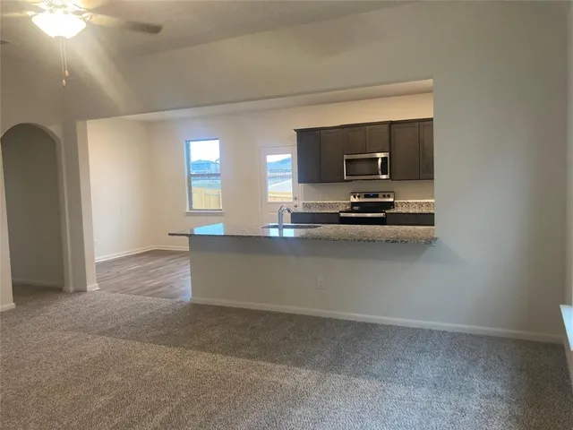a kitchen with kitchen island a stove and a refrigerator