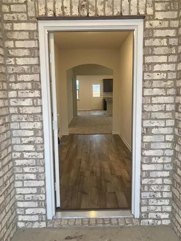 a view of a room that has a door and a window