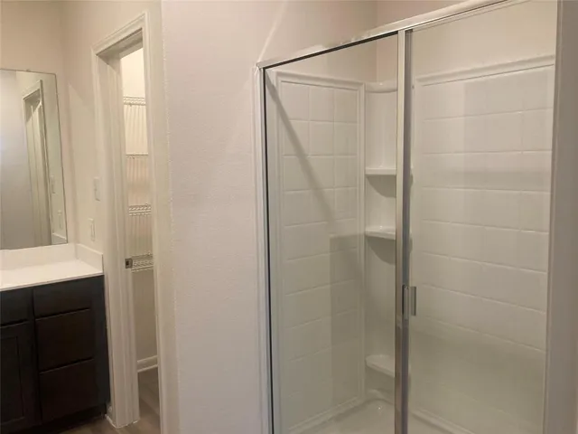 a bathroom with a glass shower door