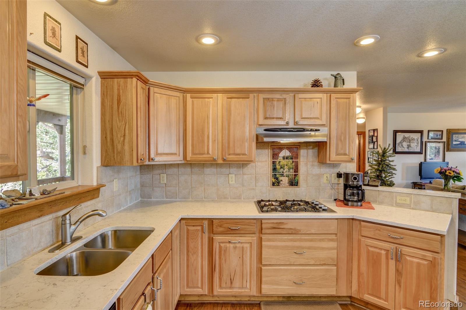 3135 Singletree Road Hartsel, CO 80449 - Photo 12 of 40 a kitchen with granite countertop a sink stainless steel appliances and cabinets