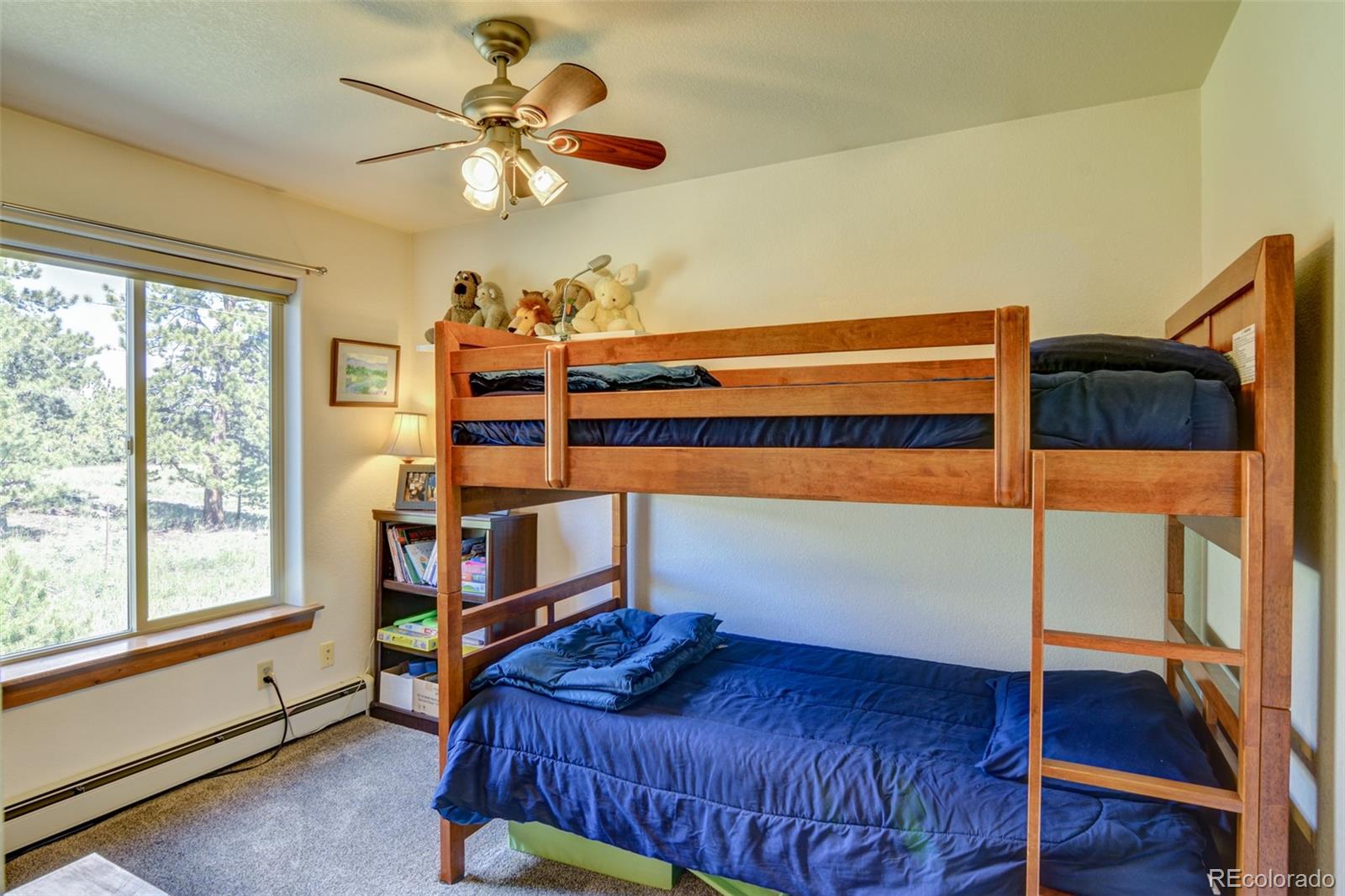 3135 Singletree Road Hartsel, CO 80449 - Photo 25 of 40 a bedroom with a bed and a chandelier fan