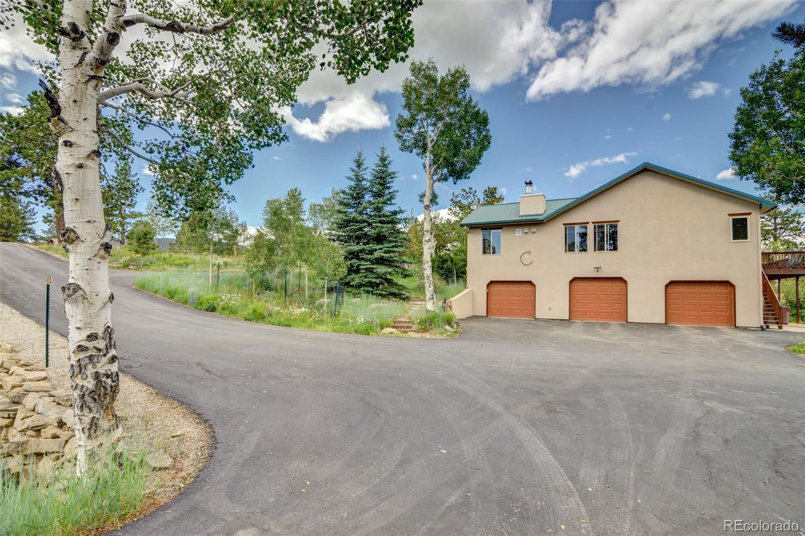 3135 Singletree Road Hartsel, CO 80449 - Photo 3 of 40 a view of a house with a yard and garage
