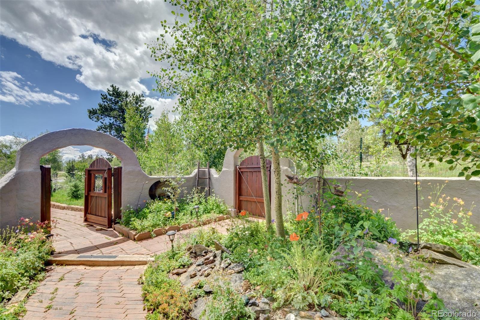 3135 Singletree Road Hartsel, CO 80449 - Photo 33 of 40 a front view of a house with garden