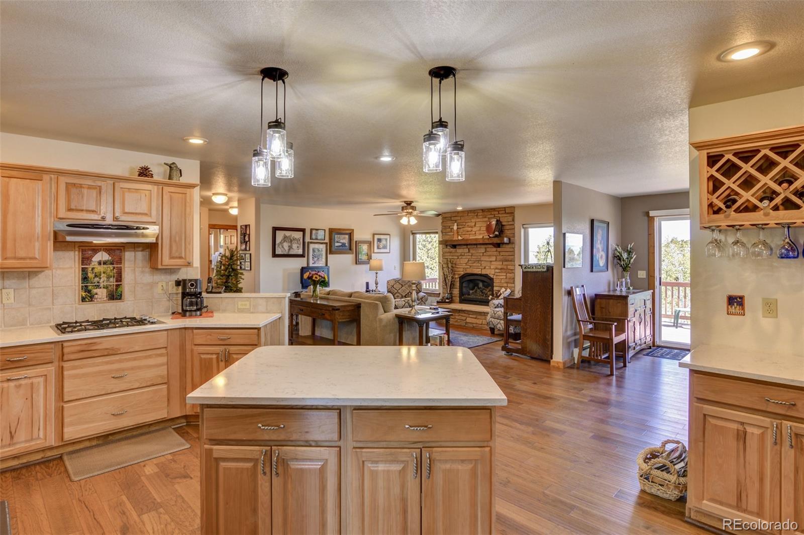 3135 Singletree Road Hartsel, CO 80449 - Photo 6 of 40 a view of a kitchen and dining room cabinets with wooden floor
