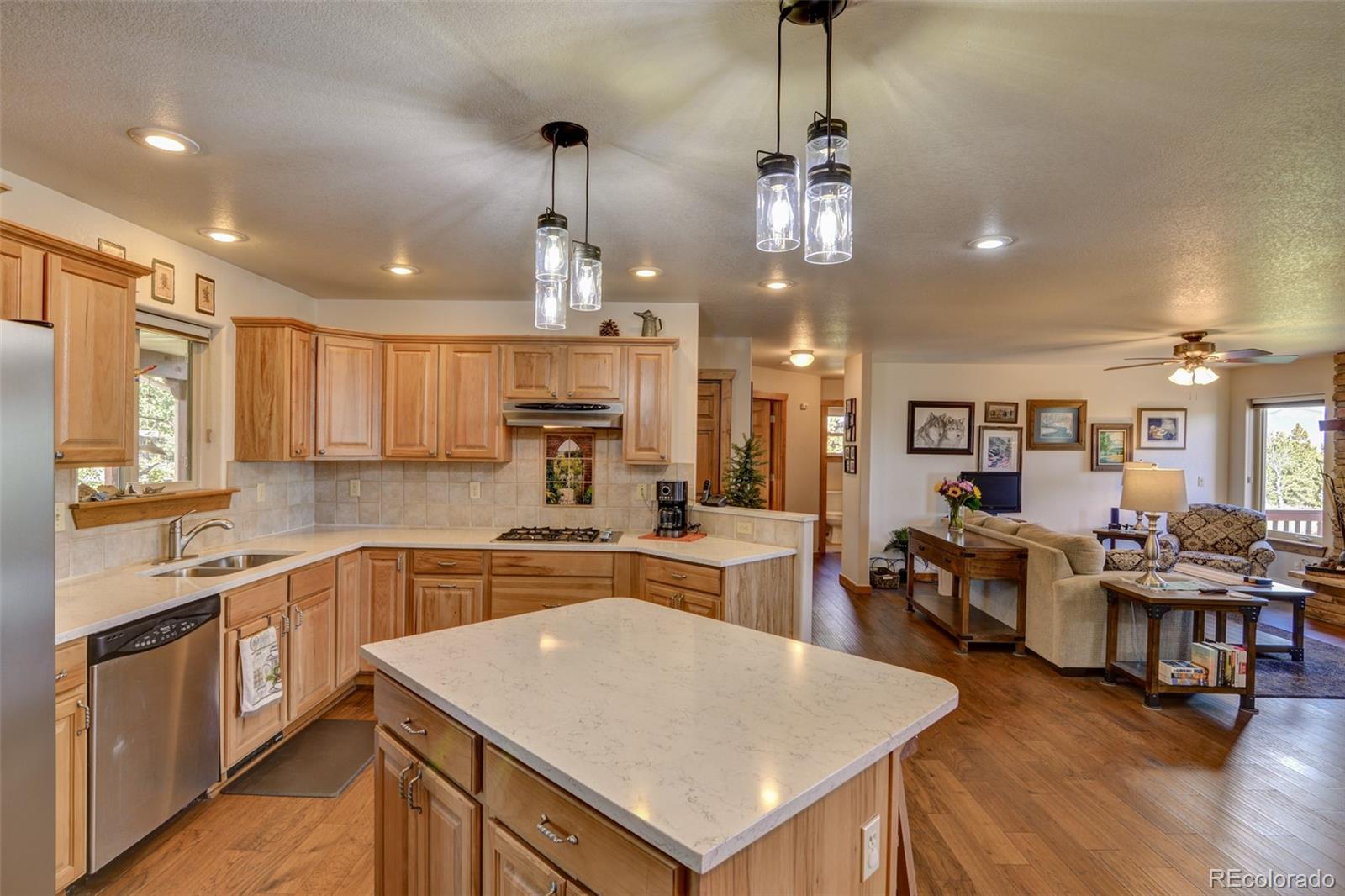 3135 Singletree Road Hartsel, CO 80449 - Photo 7 of 40 a large kitchen with lots of counter space a sink appliances and dining table