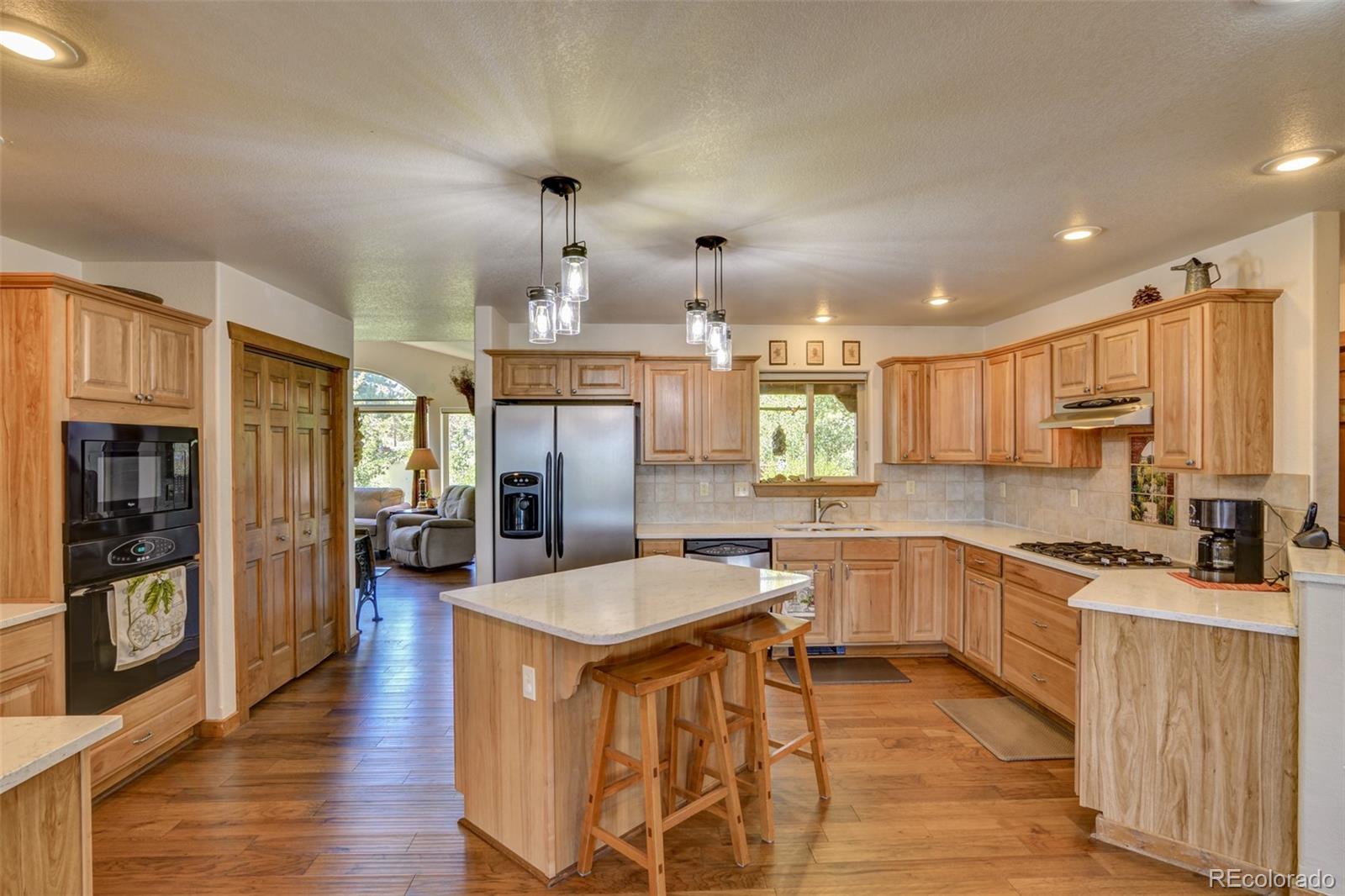 3135 Singletree Road Hartsel, CO 80449 - Photo 9 of 40 a kitchen with stainless steel appliances granite countertop a sink stove and refrigerator