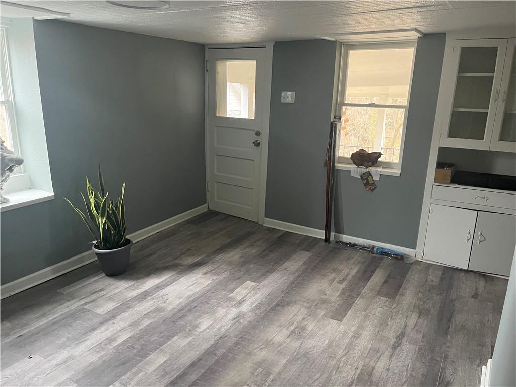 882 Center Road Pittsburgh, PA 15239 - Photo 6 of 13 a view of empty room with window and wooden floor