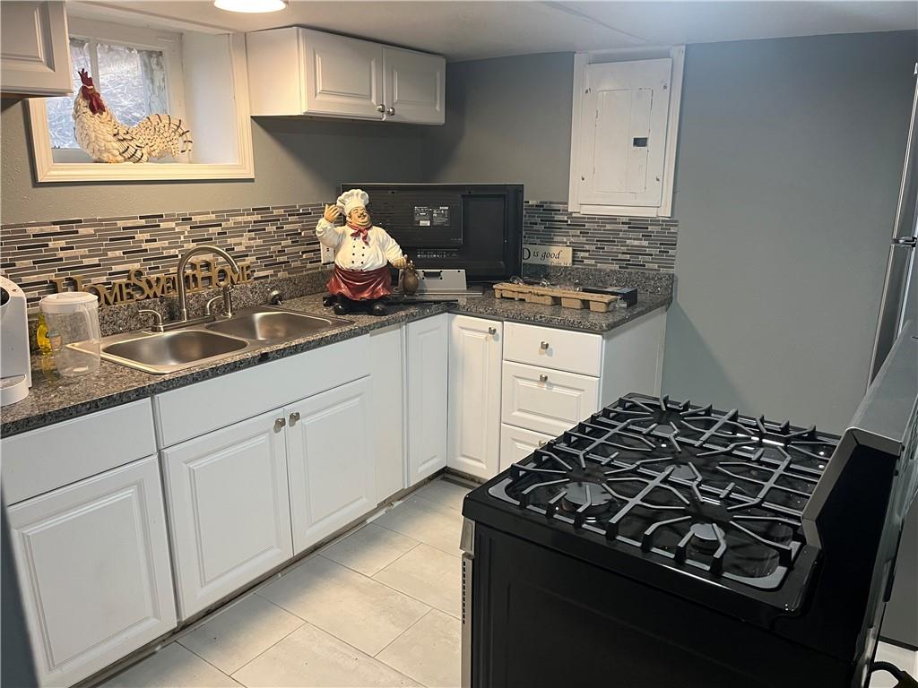 882 Center Road Pittsburgh, PA 15239 - Photo 9 of 13 a kitchen with granite countertop a sink stove and cabinets