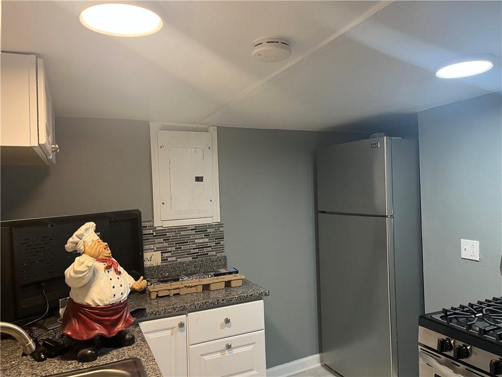 882 Center Road Pittsburgh, PA 15239 - Photo 10 of 13 a kitchen with a refrigerator and a stove