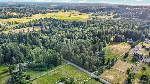an aerial view of residential houses with outdoor space and swimming pool