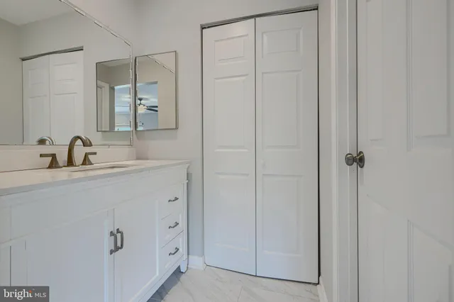 a bathroom with a sink and vanity