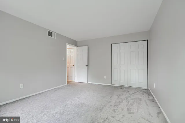a view of an empty room and closet area
