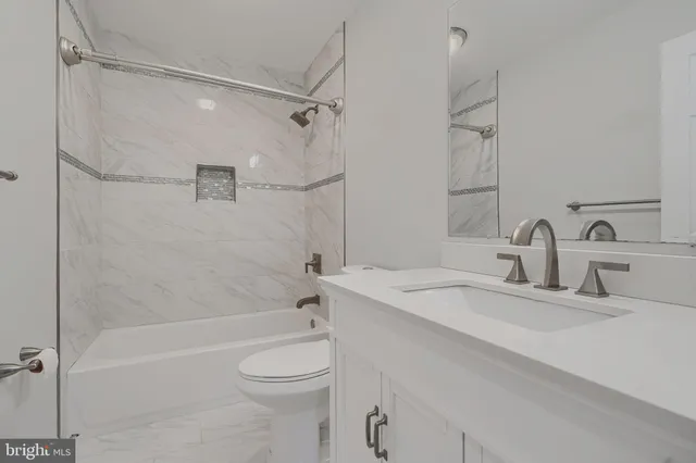 a bathroom with a sink toilet vanity and shower