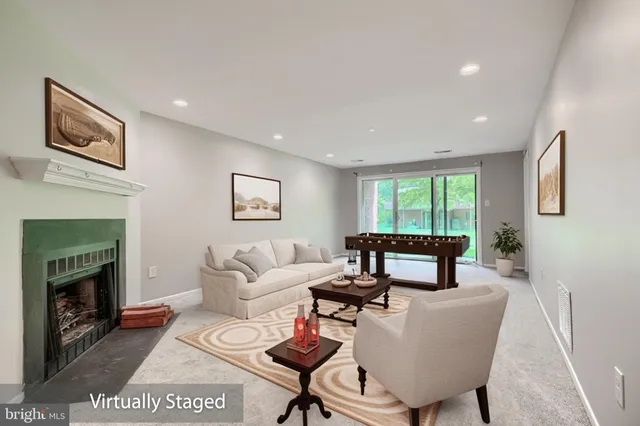 a living room with furniture a window and a fireplace