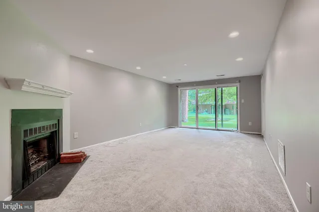 a view of an empty room with a fireplace