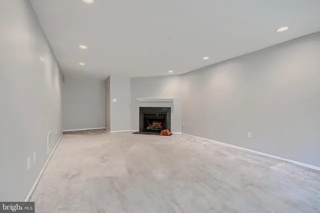 a view of an empty room with a fireplace