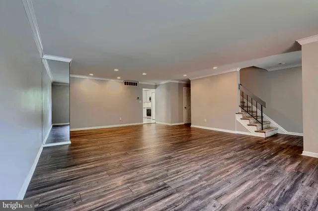 a view of a room with wooden floor