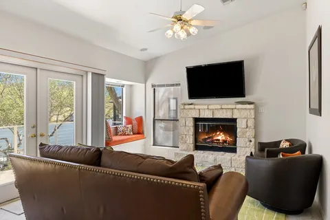 a living room with furniture a fireplace and a flat screen tv