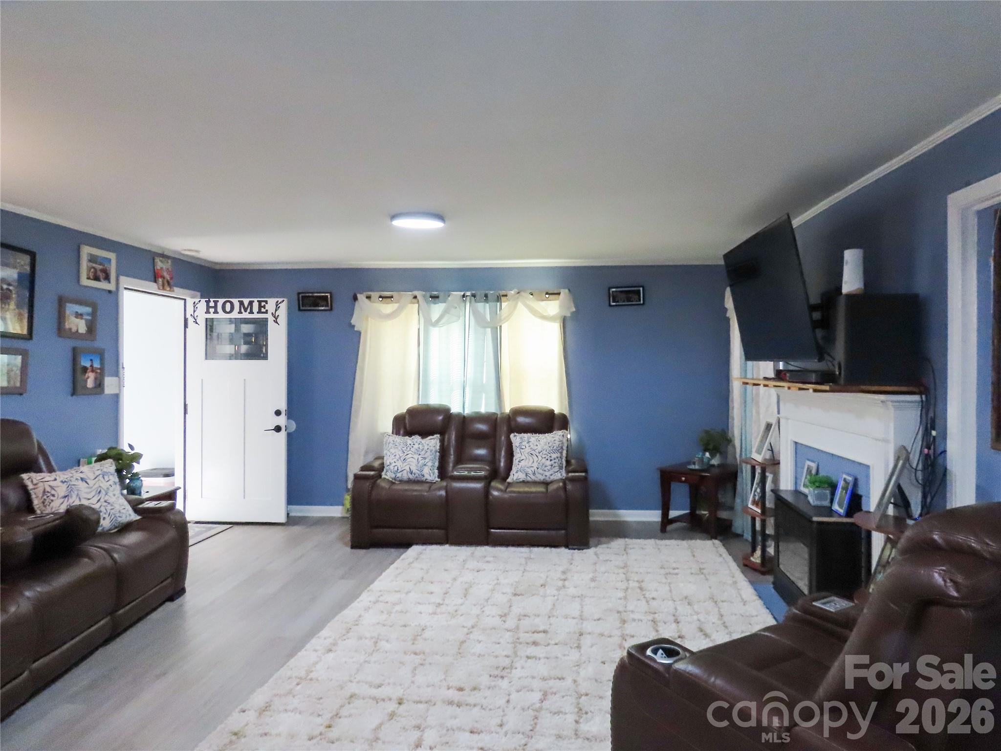 214 West Springs Street Lancaster, SC 29720 - Photo 13 of 33 a living room with furniture a flat screen tv and a window
