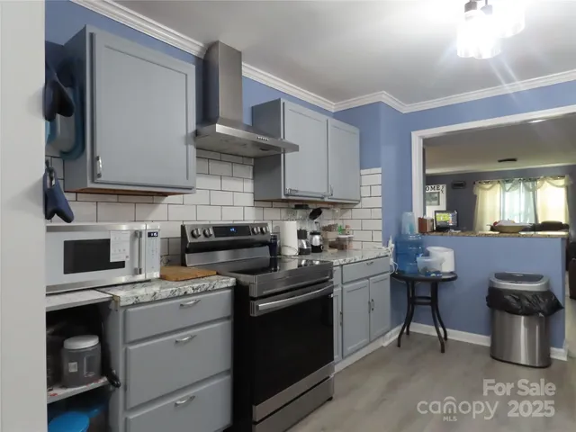 a kitchen with kitchen island a sink stove and refrigerator