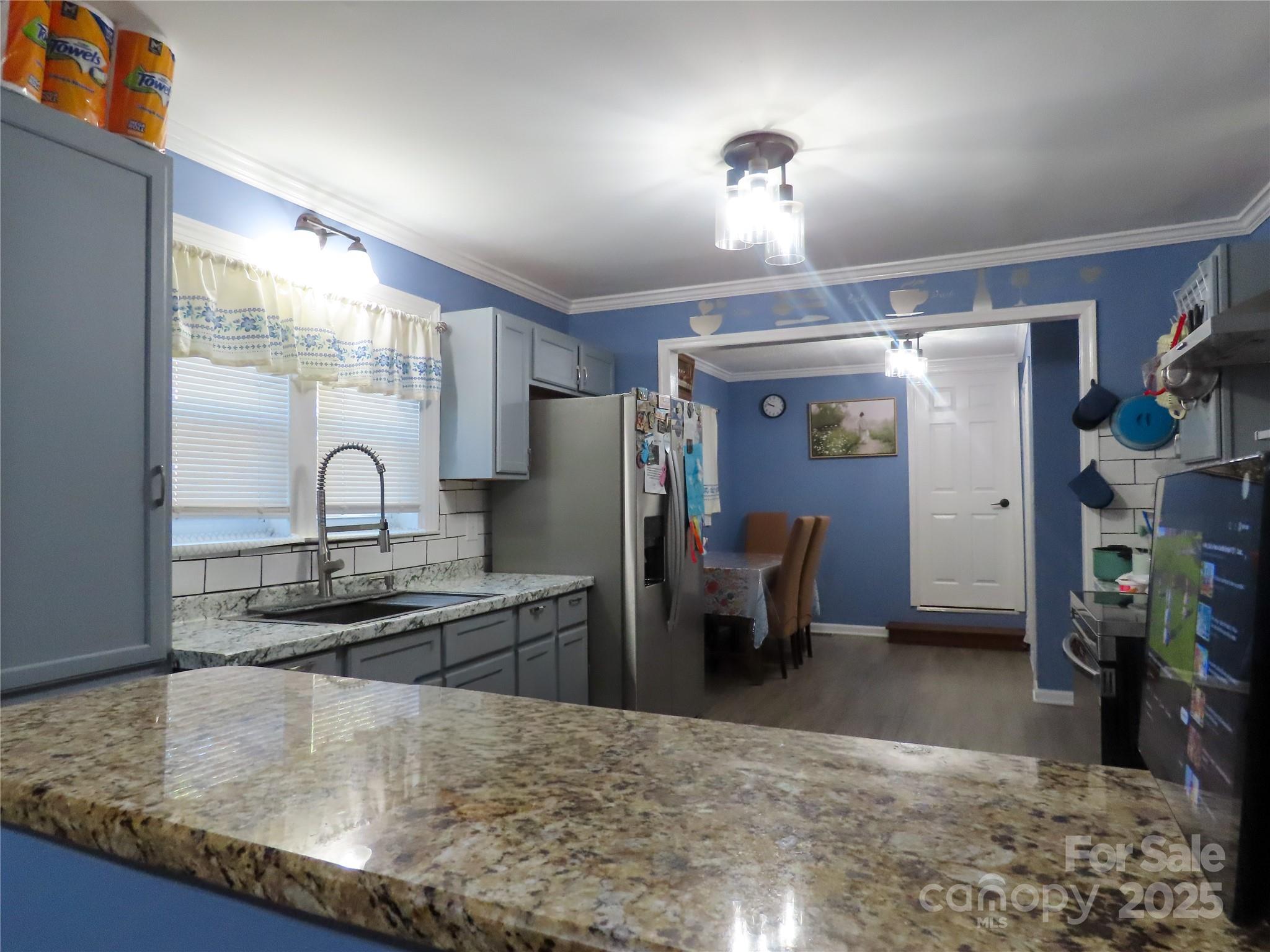 214 West Springs Street Lancaster, SC 29720 - Photo 7 of 33 a kitchen with kitchen island a sink stove and refrigerator