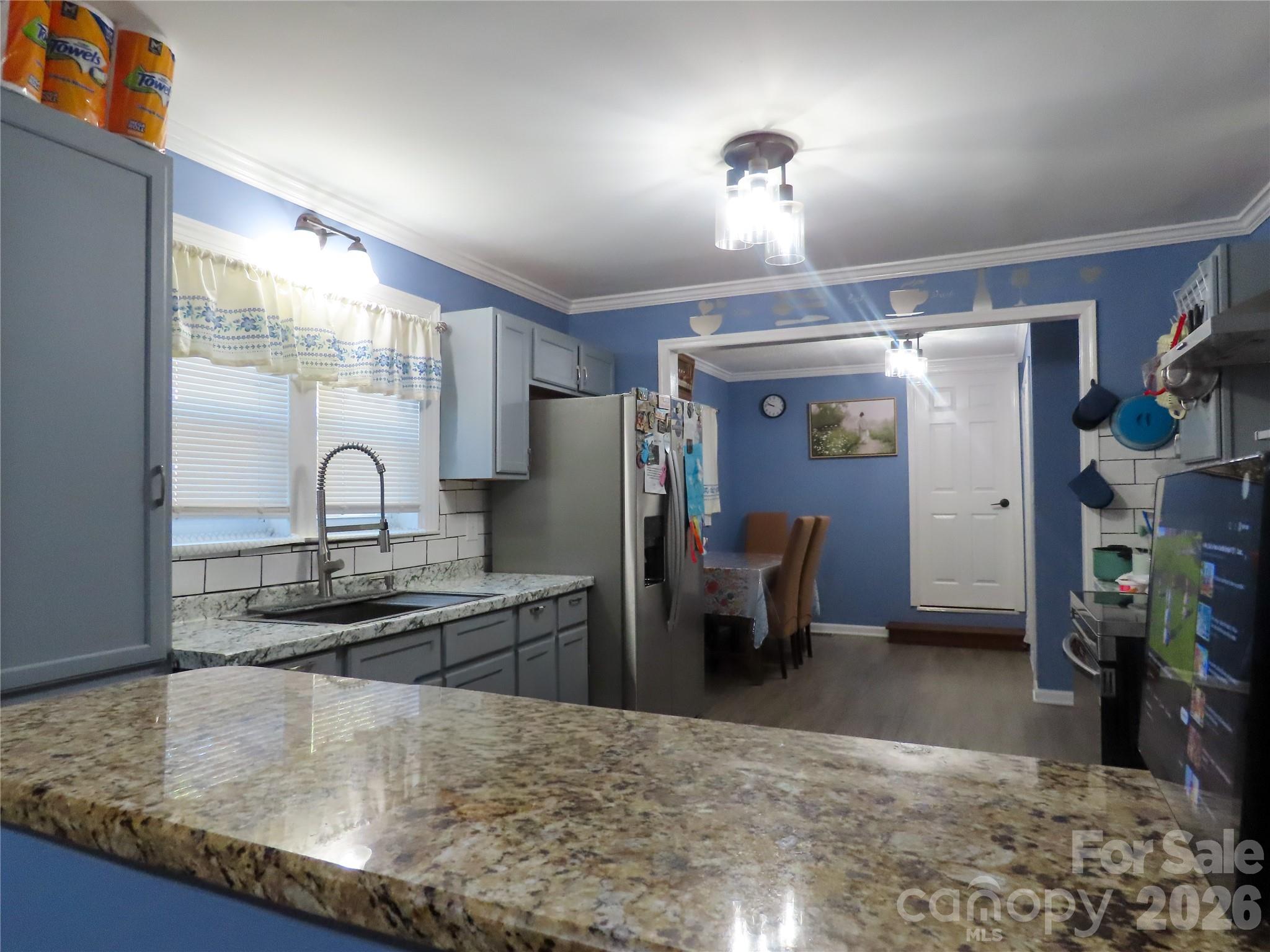 214 West Springs Street Lancaster, SC 29720 - Photo 8 of 33 a kitchen with kitchen island a sink stove and refrigerator