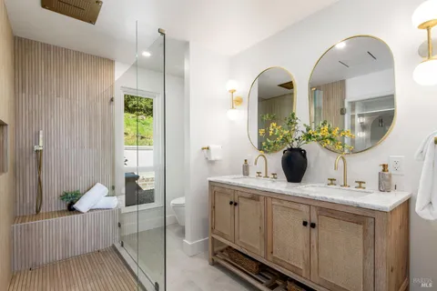 a en suite bathroom with a granite countertop sink and a mirror