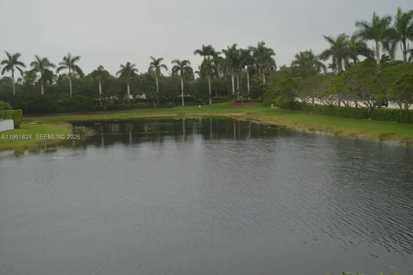 a view of a lake with houses in background