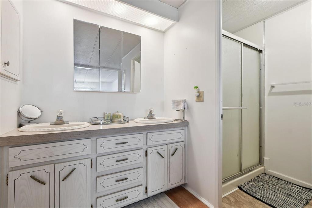 13225 101st Street Southeast, Unit 116 Largo, FL 33773 - Photo 15 of 22 a bathroom with a granite countertop sink and a mirror