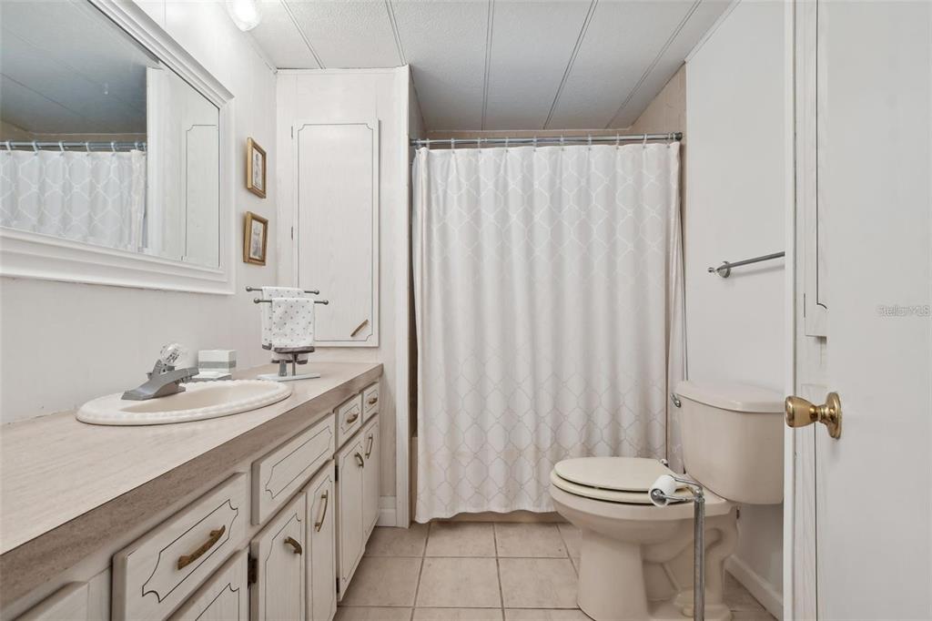 13225 101st Street Southeast, Unit 116 Largo, FL 33773 - Photo 17 of 22 a bathroom with a sink a toilet and shower