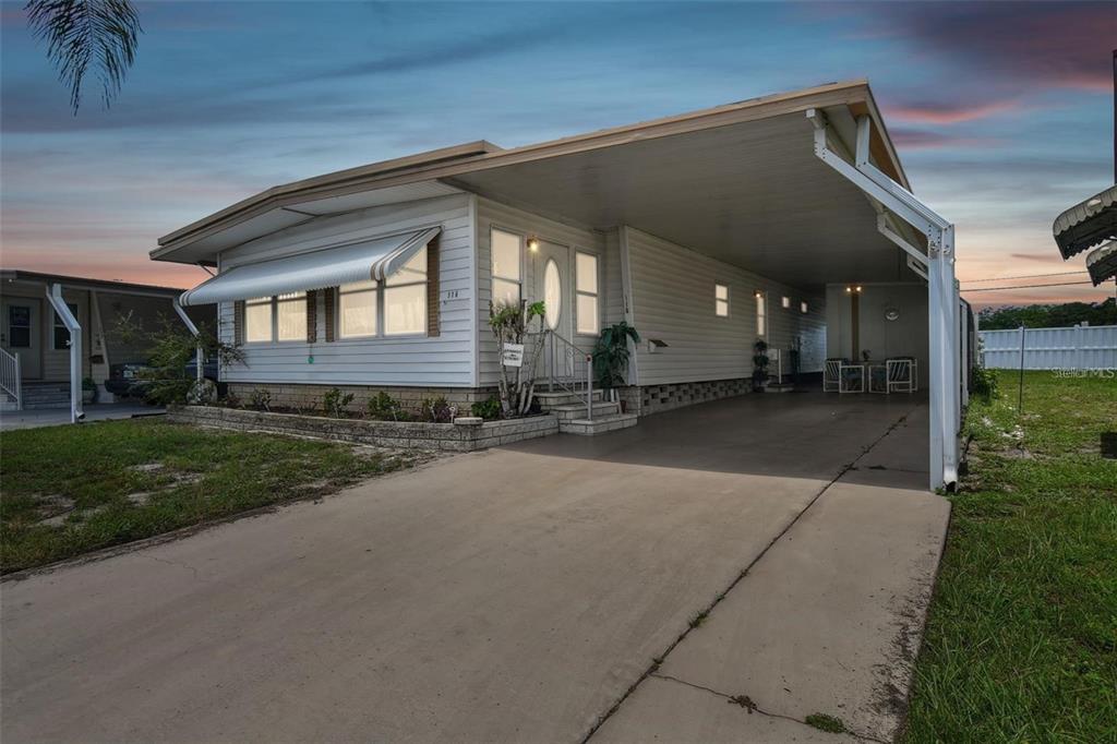 13225 101st Street Southeast, Unit 116 Largo, FL 33773 - Photo 18 of 22 a view of a house with a yard