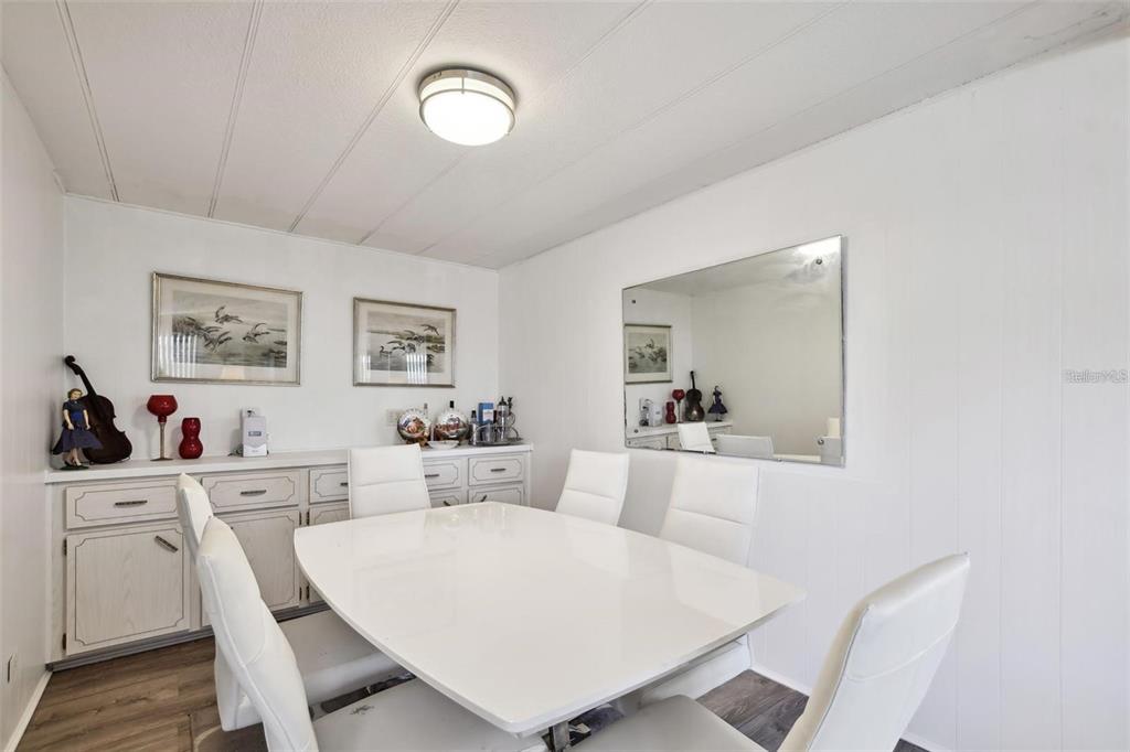 13225 101st Street Southeast, Unit 116 Largo, FL 33773 - Photo 5 of 22 a view of a dining room with furniture and wooden floor