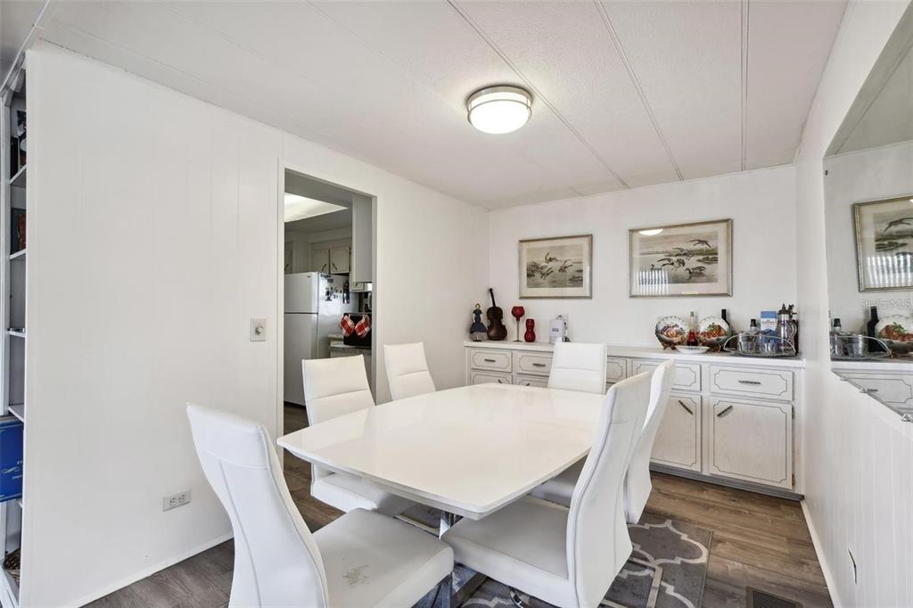 13225 101st Street Southeast, Unit 116 Largo, FL 33773 - Photo 6 of 22 a view of a dining room with furniture and wooden floor
