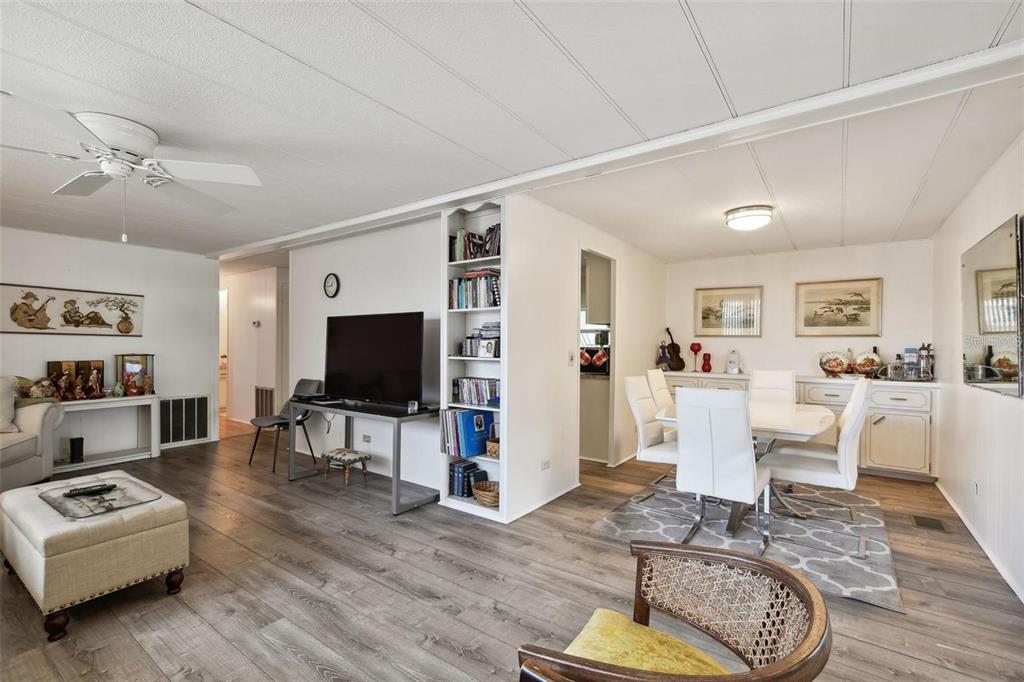 13225 101st Street Southeast, Unit 116 Largo, FL 33773 - Photo 7 of 22 a living room with furniture and a flat screen tv