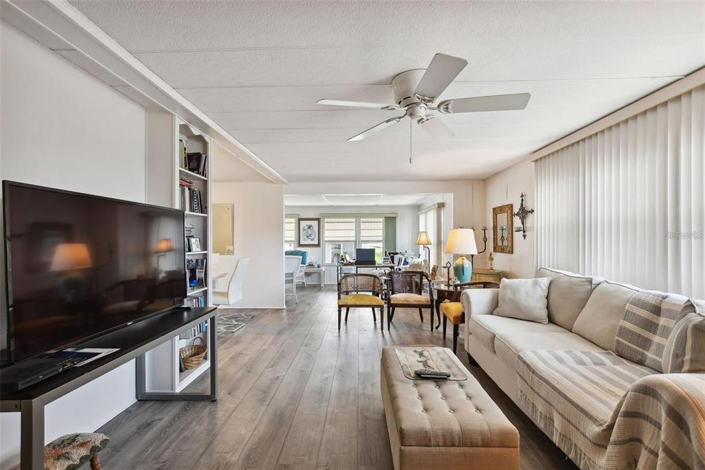 13225 101st Street Southeast, Unit 116 Largo, FL 33773 - Photo 9 of 22 a living room with furniture and a flat screen tv