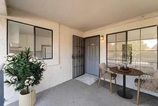 a living room with furniture and a potted plant