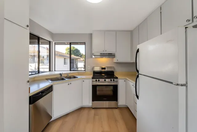 a view of a room with wooden floor and windows