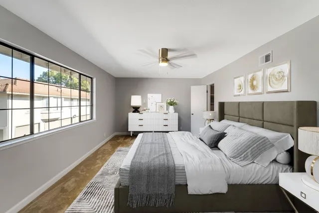 a bedroom with a large bed and a window